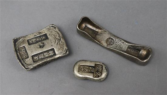 A group of three white metal ingots